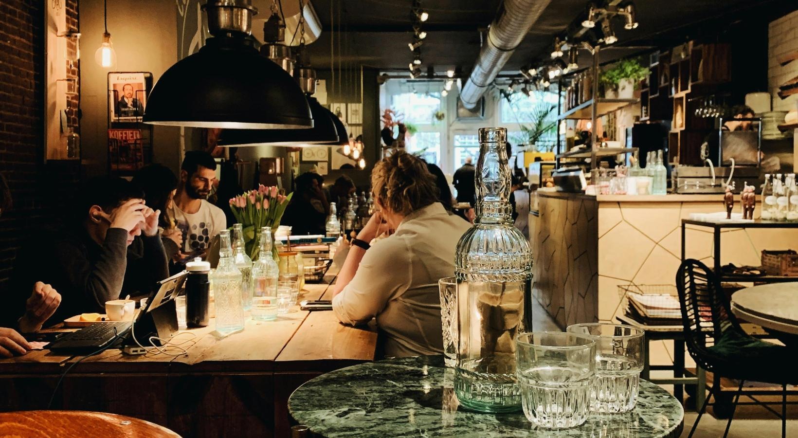 Bustling community with plenty of dining choices people sitting at tables in a restaurant