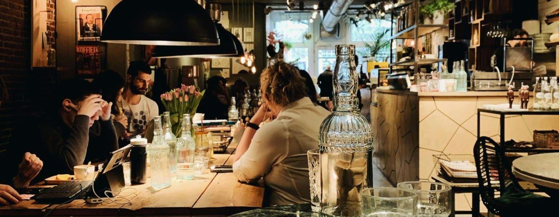 people sitting at tables in a restaurant