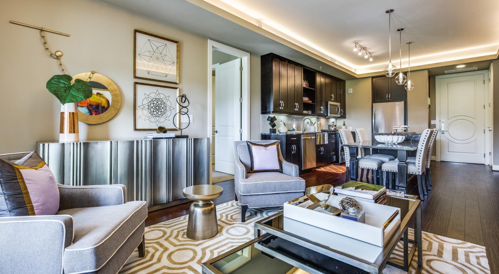 Beautiful kitchens with designer finishes a living room with a bar and chairs