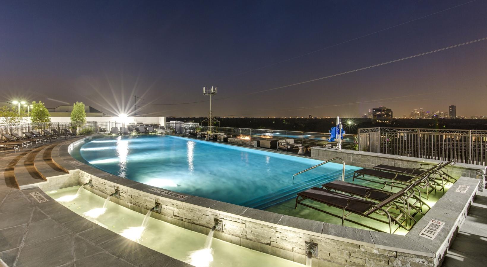Settle into comfort at The Ivy a pool with lounge chairs