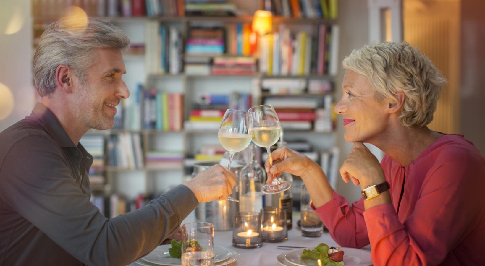 Close to the center of everything a man and a woman holding wine glasses