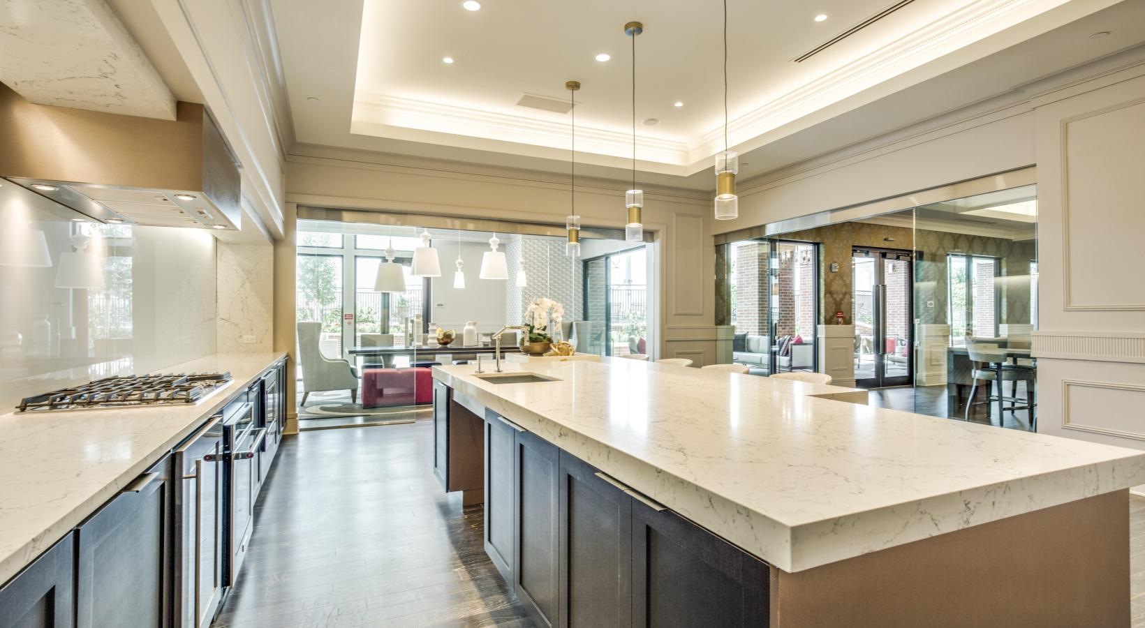 Settle into comfort at The Ivy a kitchen with a bar and island