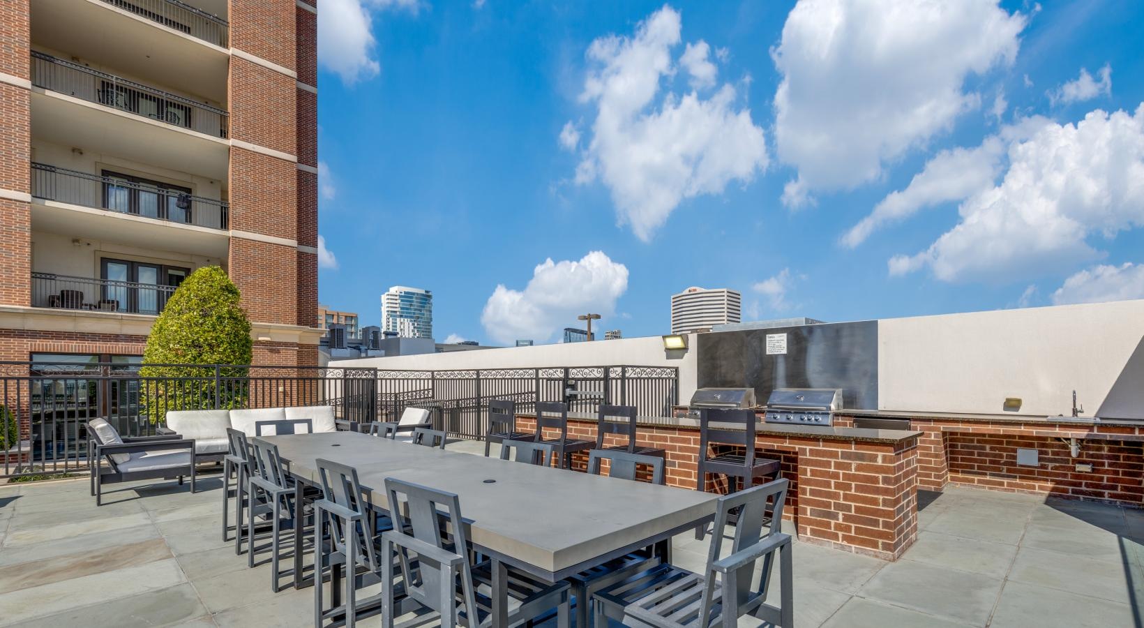 Access to resident-only features a rooftop patio with tables and chairs