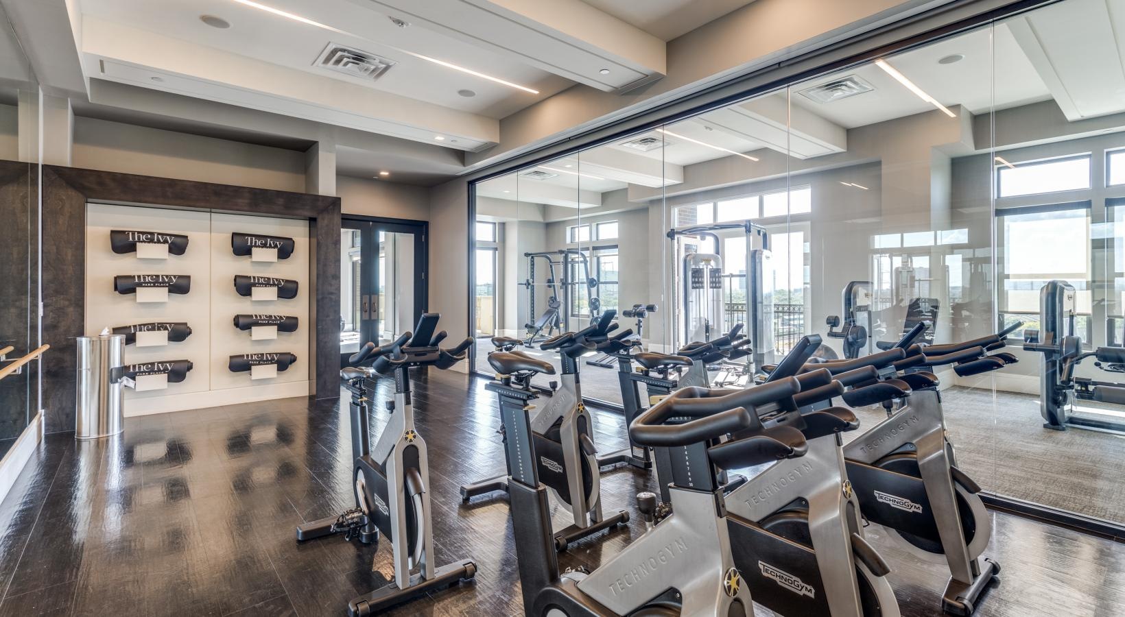 State-of-the-art amenities a gym with exercise equipment