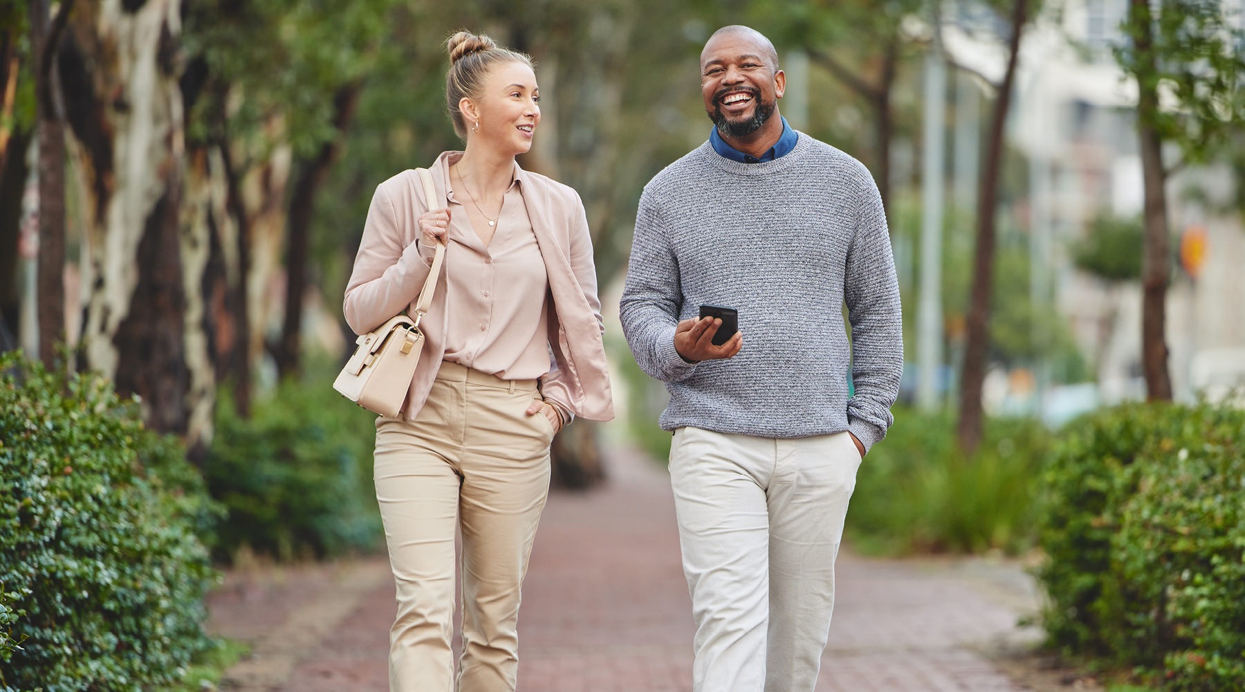 A beautiful community at the heart of all your passions a man and a woman walking outside