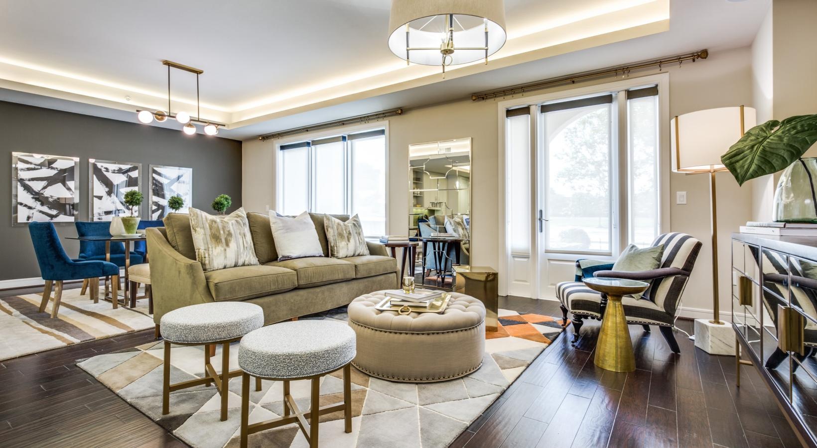 Spacious and well-lit living spaces a living room with a large chandelier and a large window