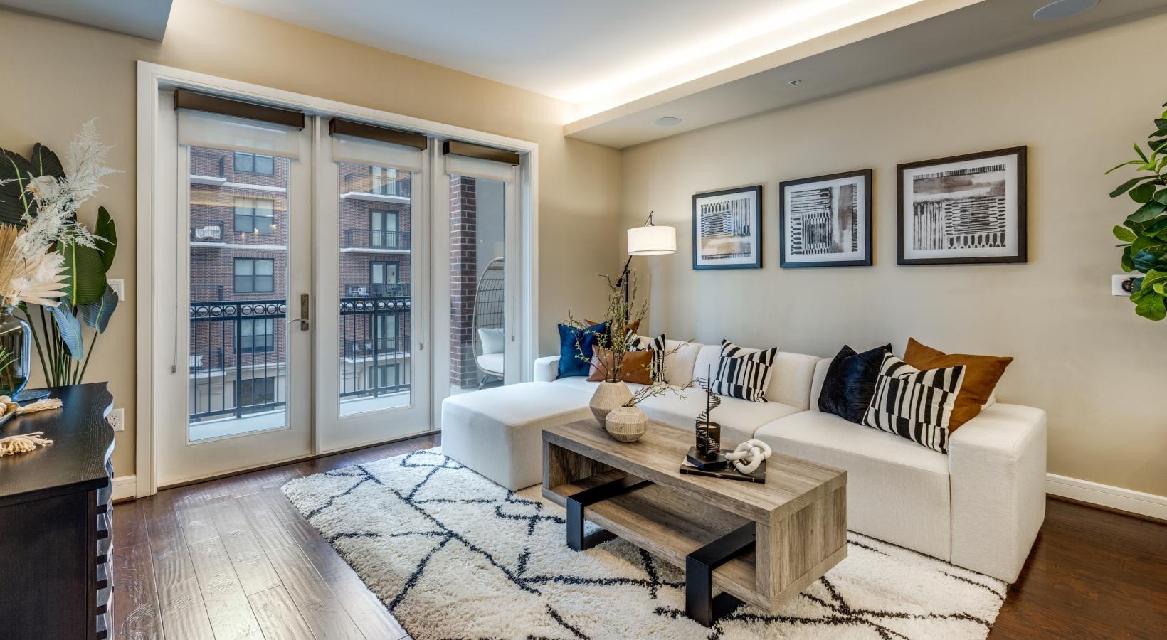 Generous living spaces with beautiful natural lighting a living room with a couch and a coffee table