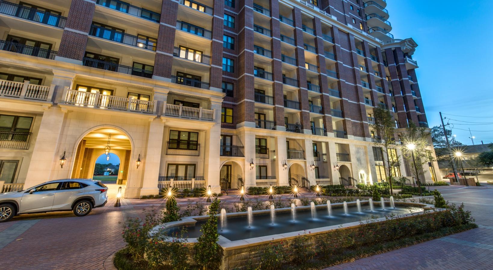 Find your perfect fit at The Ivy a building with a car parked in front  and a fountain