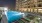 a pool on a rooftop with lounge chairs