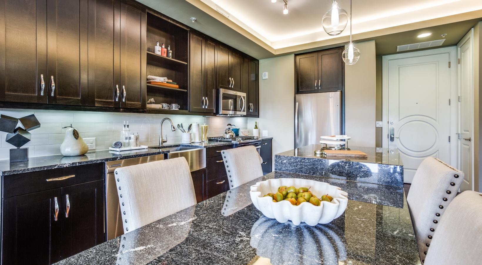 Settle into comfort at The Ivy a kitchen with black cabinets