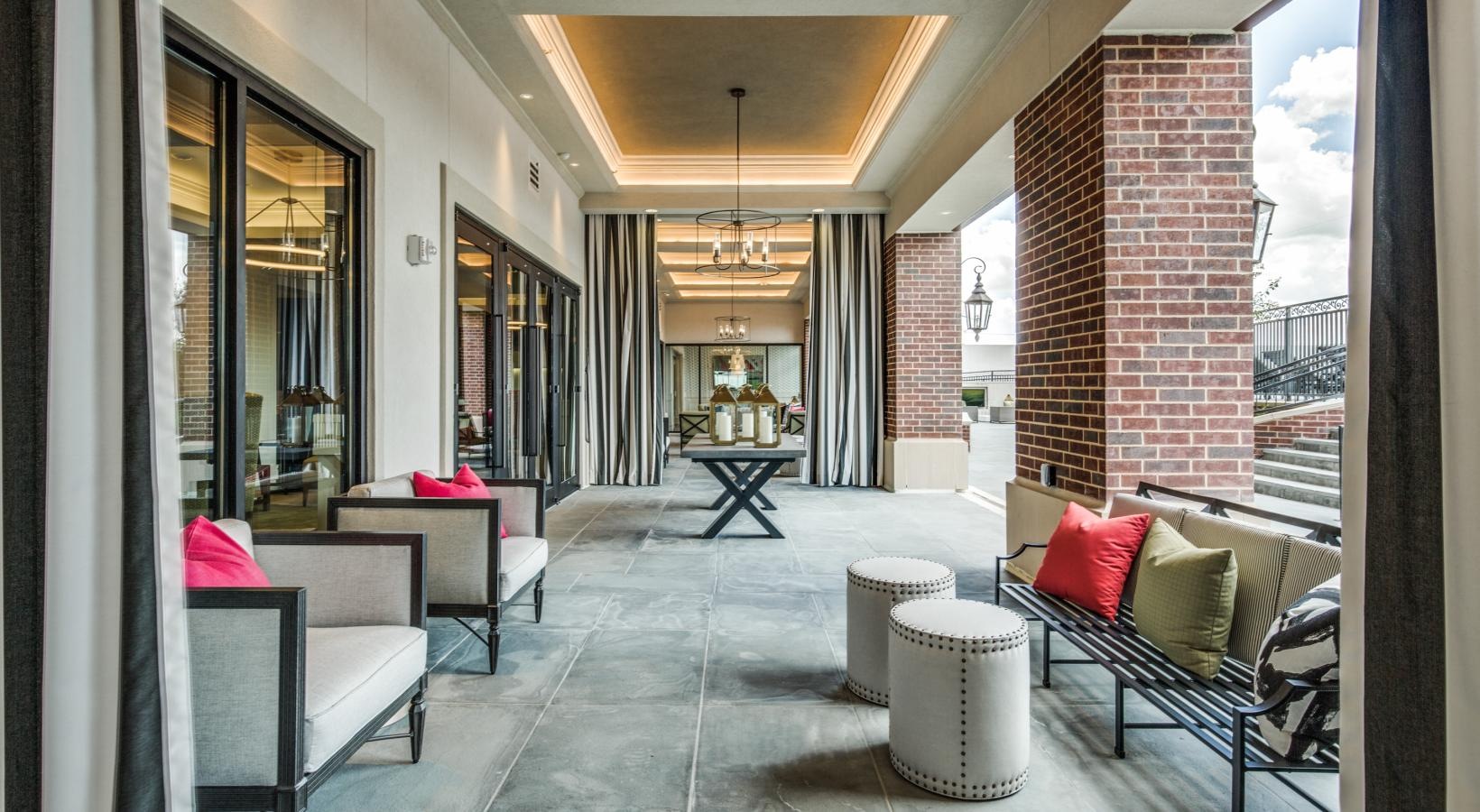 Everything within reach a covered walkway with chairs and lights and brick pillars