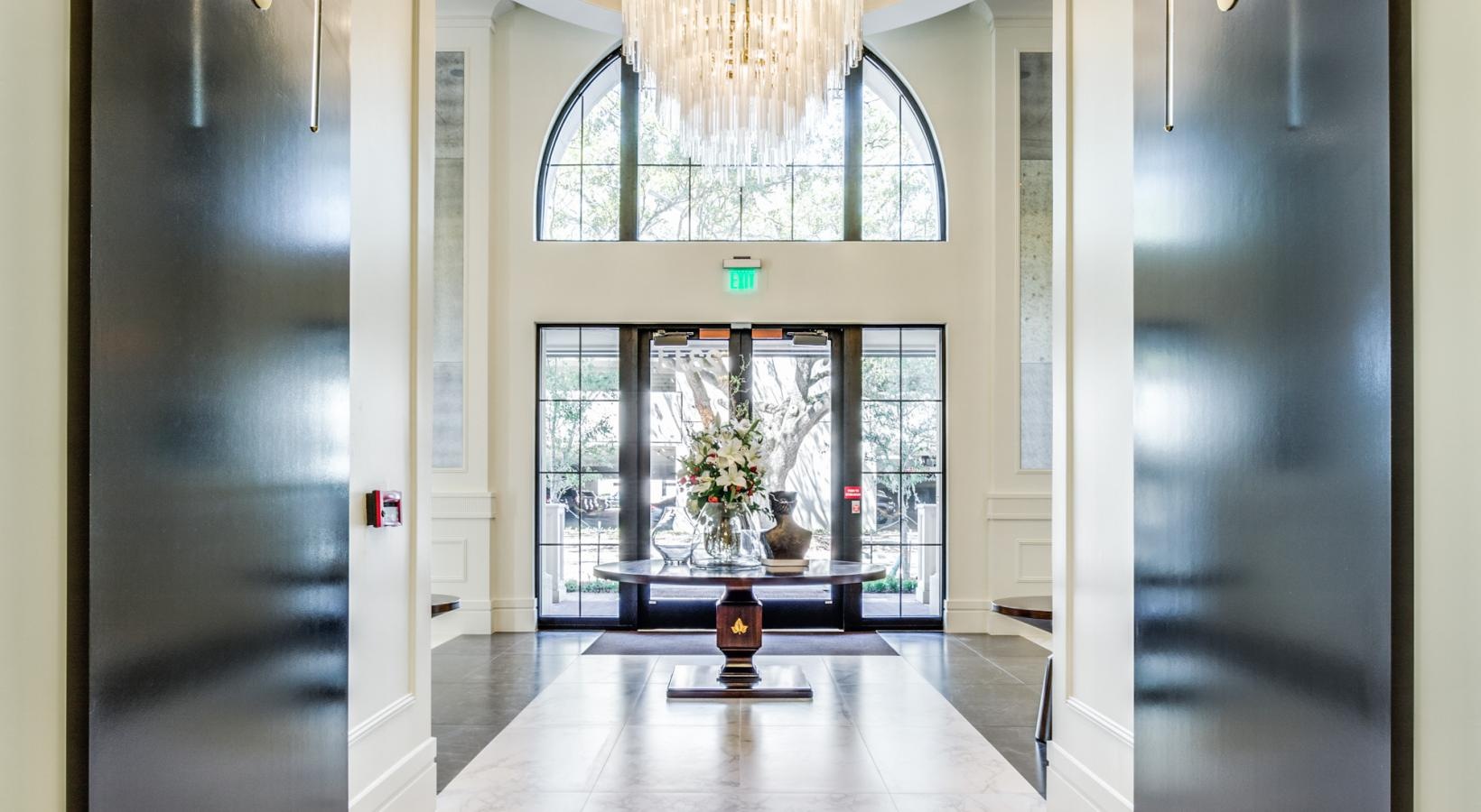 Take advantage of all The Ivy has to offer a chandelier hanging from a ceiling in a room with a tiled floor